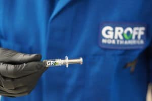 a hand holding a groff sample with a groff north america lab jacket on